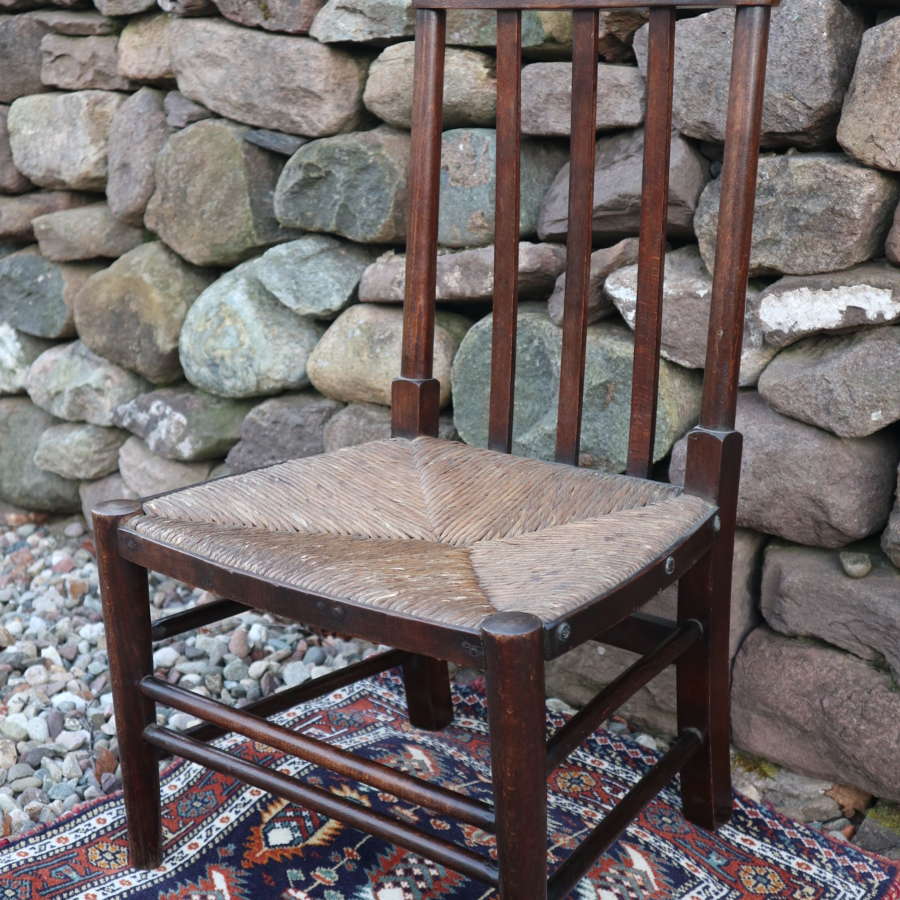 Arts & Crafts style child's dark oak & rush seated wooden chair c.194
